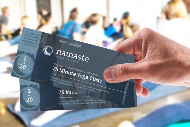 A hand holding a bundle of class tickets.